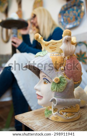 Decorated ceramic head of a soldier on the worktable of a pottery decorator in Caltagirone