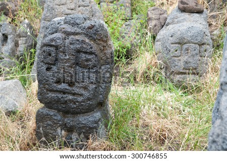 Lava stone sculpture of a man\'s head poured with water to make its design stand out