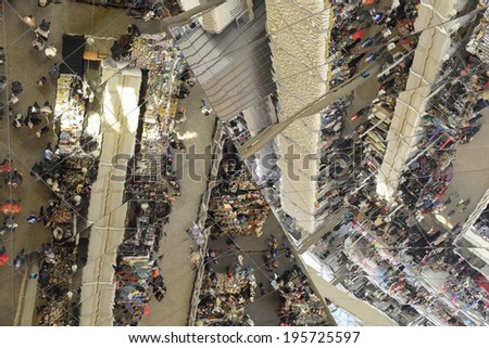 Barcelona, Spain - March 12, 2014: Unidentified people and market stalls reflected on a mirror ceiling of the most famous flea market in Barcelona, also known Els Encants Vells.