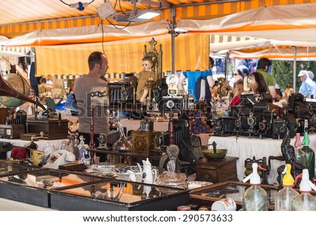 Barcelona, Spain - June 17, 2015: Flea market located in front of Barcelona Cathedral. In the picture you see a seller and customers in a place where they predominate the old cameras