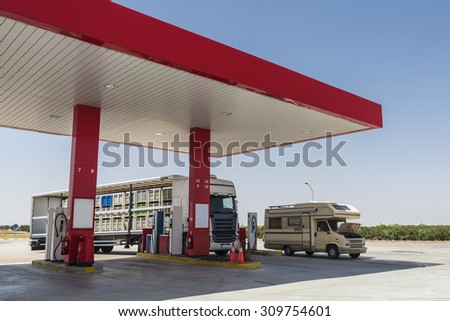 Gas station with a motorhome and a truck parked in Spain