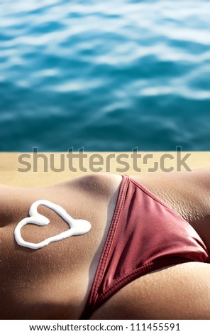 Woman body sunbathing with lotion