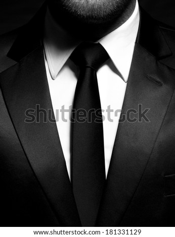 Man gentleman in black suit and tie