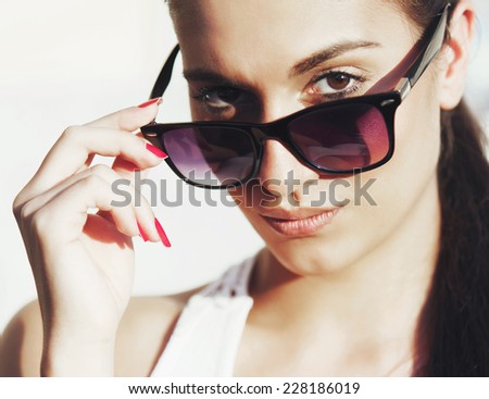 Young woman portrait with sun glasses and pony tail
