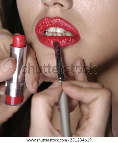 Make up, applying lipstick,stage studio real time shot