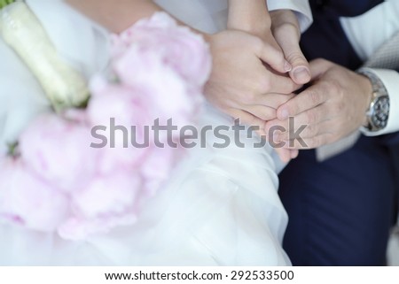 Wedding couple with bouquet. Female and male portrait. Beautiful model girl in white dress. Man in suit. Beauty bride wiÂ¬th groom. Woman in bridal gown. Cute lady and guy indoors