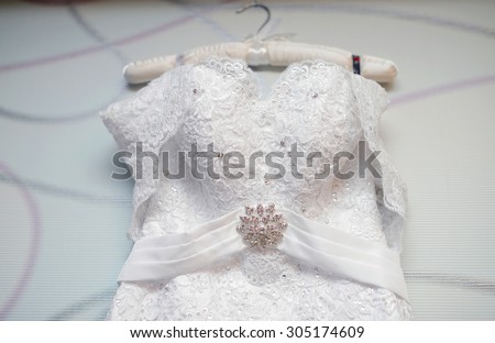 Beautiful white wedding dress for bride indoors. Beauty of bridal gown for marriage. Female lace clothes for celebration