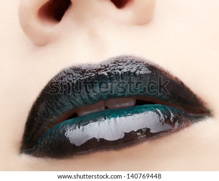 closeup portrait of young woman\'s lips zone black makeup