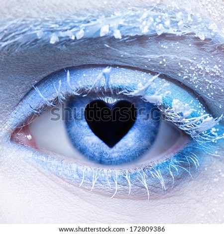 close-up  of woman\'s frozen style eye zone make up and pupil in for of heart