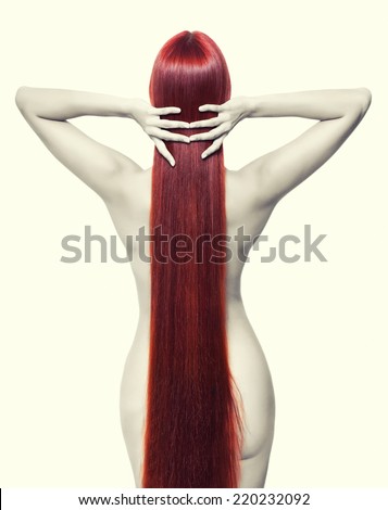 Portrait of beautiful young nude woman with long red hair. View from back side