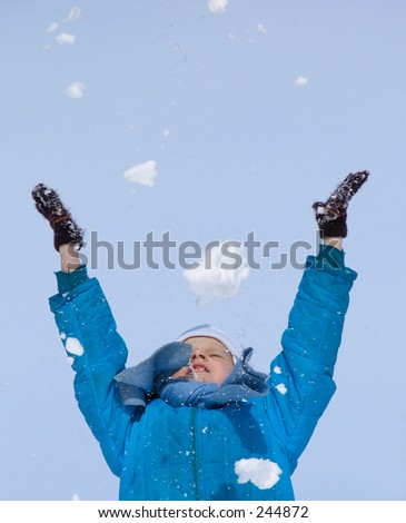 Young girl playing with snow