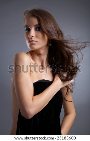 attractive young model covers her chest with black cloth