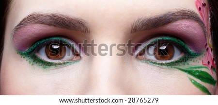 close up portrait of beautiful brunette eye\'s with eye-zone body art