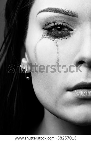 close-up portrait of beautiful crying girl with smeared mascara