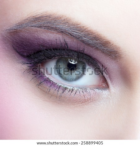 Close-up shot of female eye make-up in pink color
