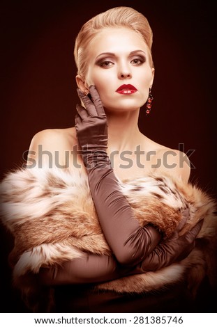 Young blonde woman in black dress and lynx fur with and long gloves on dark background toned in marsala color
