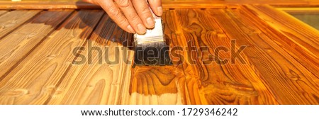 Similar – Image, Stock Photo Glaze. Woodwork, painting wood. Hand of the craftsman painting a wooden door. Concept of renovation work, carpentry and woodwork. painter, painting wooden surface, wood preservation