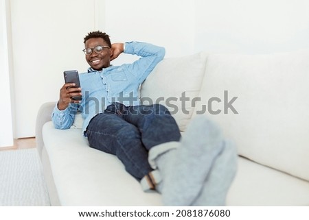 Similar – Image, Stock Photo Carefree black man lying on blanket with laptop in park