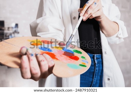 Similar – Image, Stock Photo Focused artist blending paints in palette