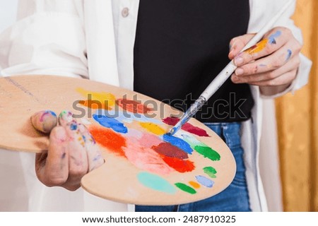 Similar – Image, Stock Photo Focused artist blending paints in palette