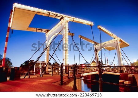 Similar – Image, Stock Photo Bridge over the Amstel river at night in Amsterdam