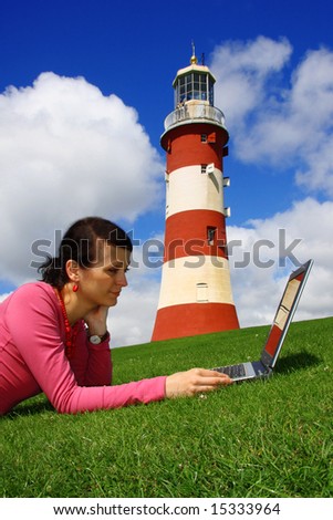 Beautiful young lady with Laptop near the lighthouse, Plymouth, England, UK