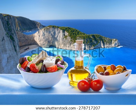 Famous Navagio beach with Greek salad in Zakynthos, Greece