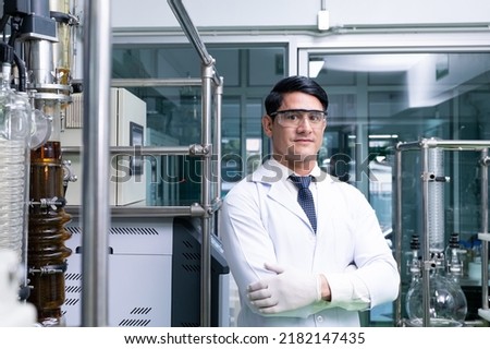 Similar – Image, Stock Photo Serious chemist examining liquid in flask in lab