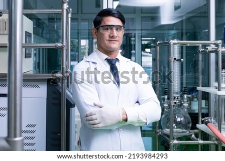 Similar – Image, Stock Photo Serious chemist examining liquid in flask in lab