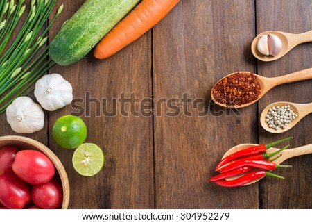 tomatoes, Red chilli, garlic and lemon on wood texture background