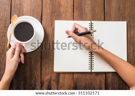 woman is drawing a something an empty paper.