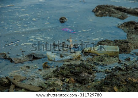 broken glass bottle on sea beach is water pollution