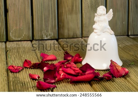 Angel figurine with rose petals