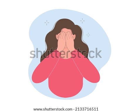 Young  woman hides her face in her hands. Concept of fear, shame, social phobia. 