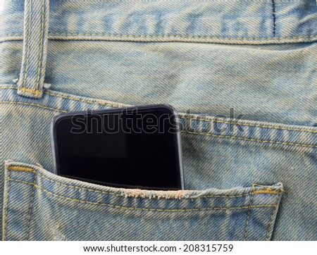 Phone in a back pocket of a denim jeans as a background