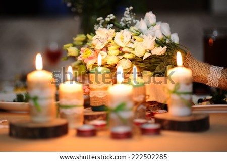 Wedding bouquet on a table with candles. Wedding in style \
