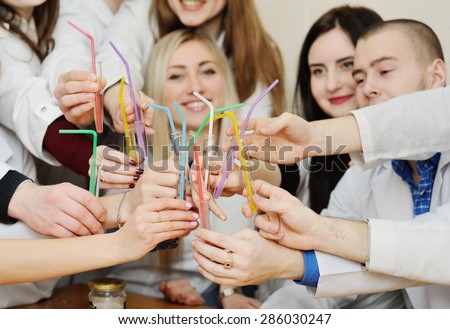 medical students with medical beakers and cocktail straws celebrate Day of Medical Worker
