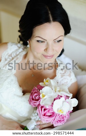 beautiful bride with a wedding bouquet of orchids