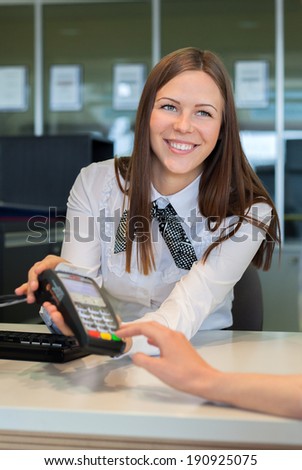 Bank worker offer to pay by credit card in bank with smile
