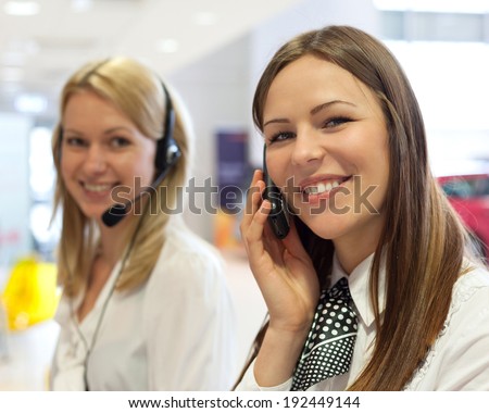 business people with phone and headphones giving support in help desk office to customers, manager giving training and education instructions