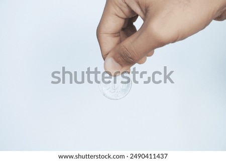 Similar – Image, Stock Photo hand holding 500 coins indonesian rupiah