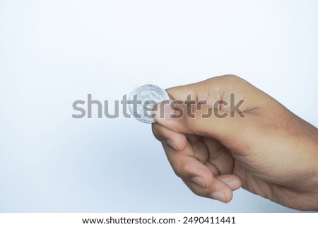 Similar – Image, Stock Photo hand holding 500 coins indonesian rupiah