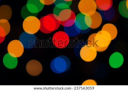Bright festive background with colorful round lights.Festive illuminations defocused