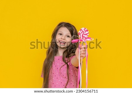 Similar – Image, Stock Photo Girl with lollipops in the form of a kiss