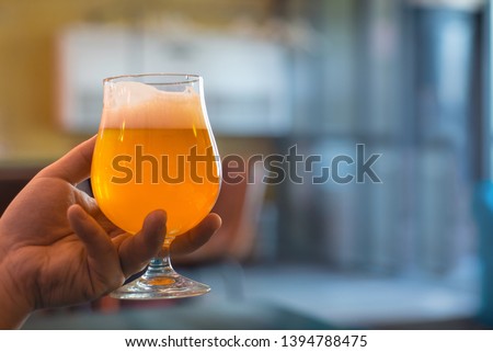 Similar – Image, Stock Photo A fresh beer (Kölsch) is tapped at the tap in a bar