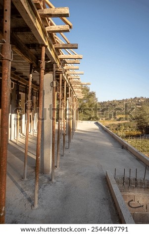 Image, Stock Photo Supported wooden beam, above which a window lets light into the building site.