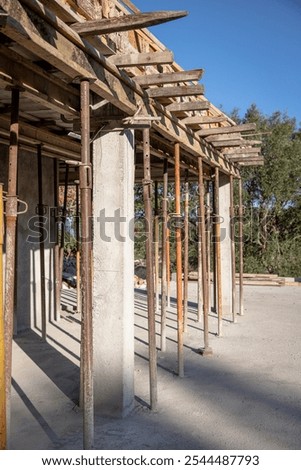 Similar – Image, Stock Photo Supported wooden beam, above which a window lets light into the building site.