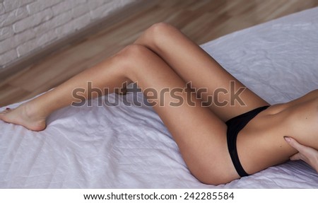 Beautiful slim long legs on bed