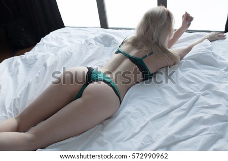 Young Woman Ass With Green Lingerie On White Bed 572990962 Young Woman Ass With Green Lingerie On White Bed 572990962