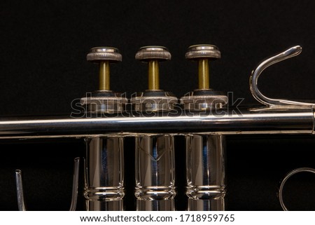 A dark shot of a professional model trumpet's valve set with brass stems. Stock fotó © 